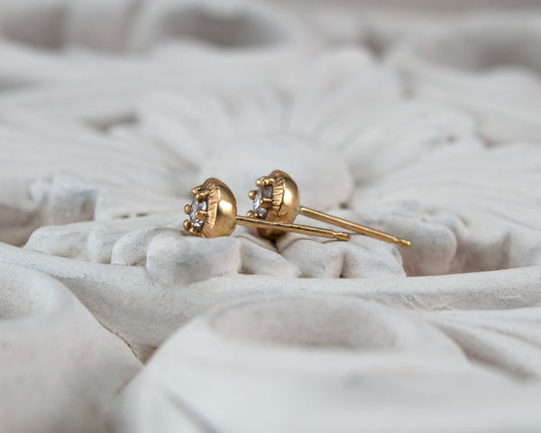 Unique diamond stud earrings with vintage style, side view