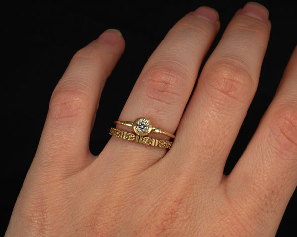 Gold floral wedding band, eternity style modeled