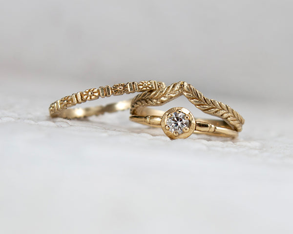 solid 14k gold, floral wedding band with other rings