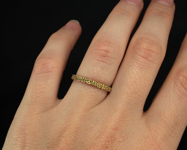 Gold floral wedding band, eternity style modeled