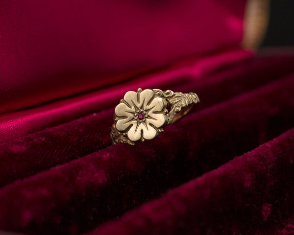Vintage style flower ring with a ruby center, front view
