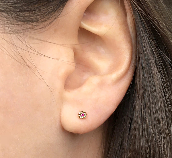 Solid 14k gold, tiny flower stud earrings with rubies modeled