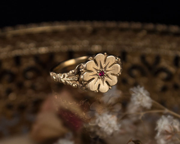 Vintage style flower ring with a ruby, front view