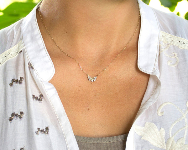 dainty 14k gold necklace, with five diamonds modeled