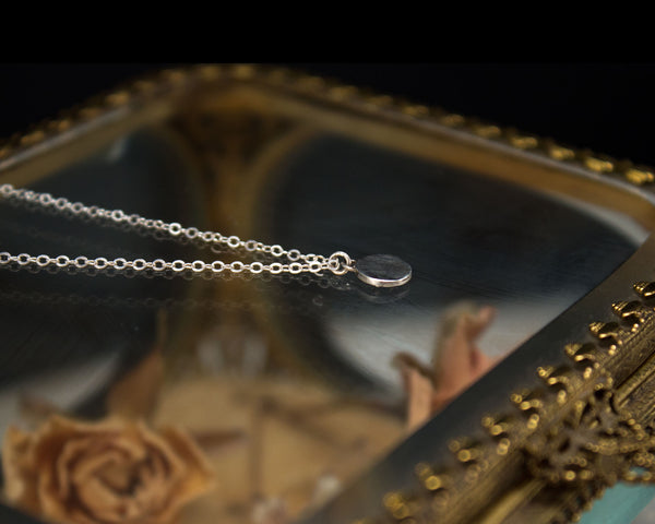reverse of small skull necklace, sterling silver