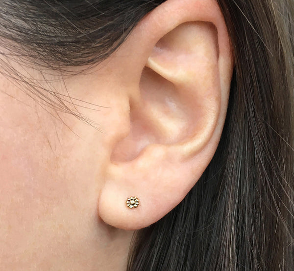 14k gold, tiny flower stud earrings modeled