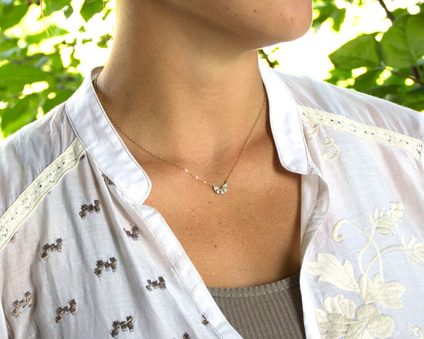 dainty 14k gold necklace, with five diamonds modeled