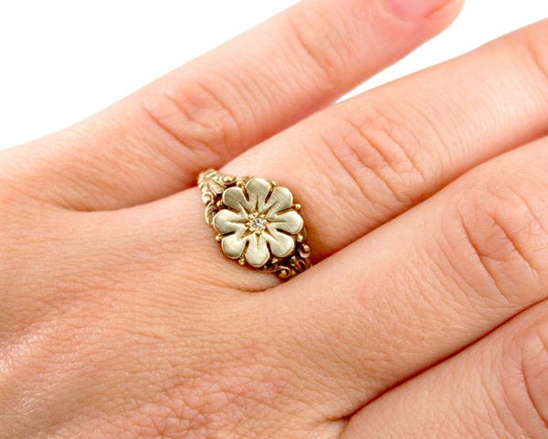 Vintage style flower ring with a diamond center, modeled