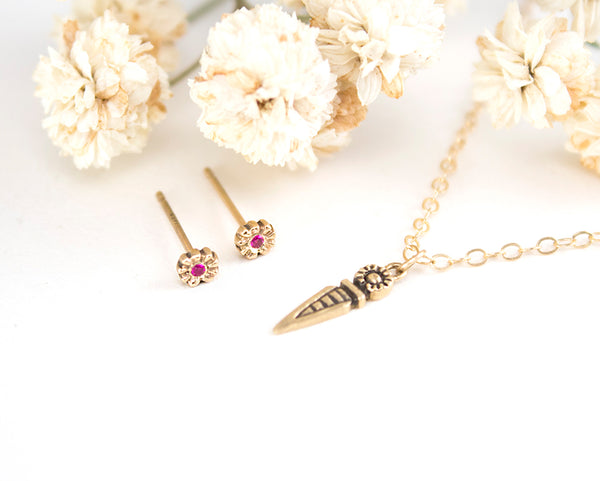 Solid 14k gold, tiny flower stud earrings with rubies, top view