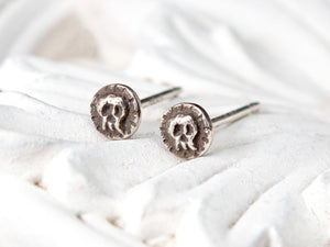 Small sterling silver skull stud earrings