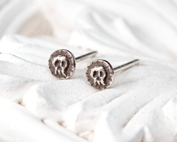Small sterling silver skull stud earrings