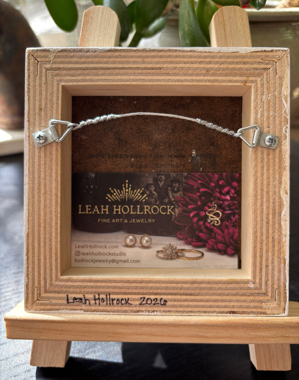 the back of an original painting showing the hanger and details