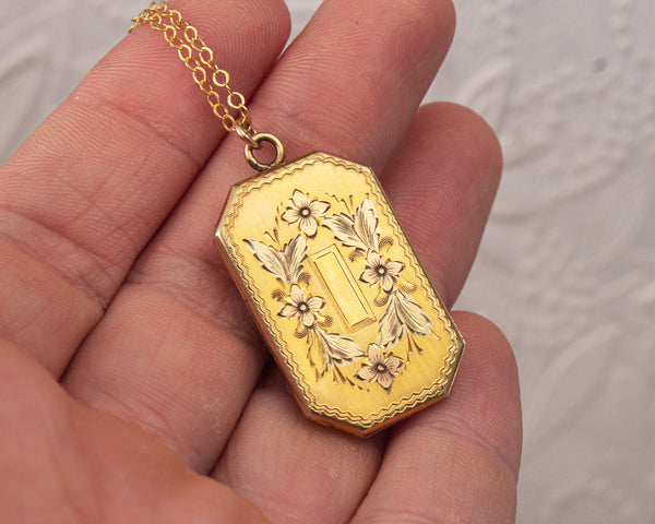 Front of Vintage locket with tree and bird painting