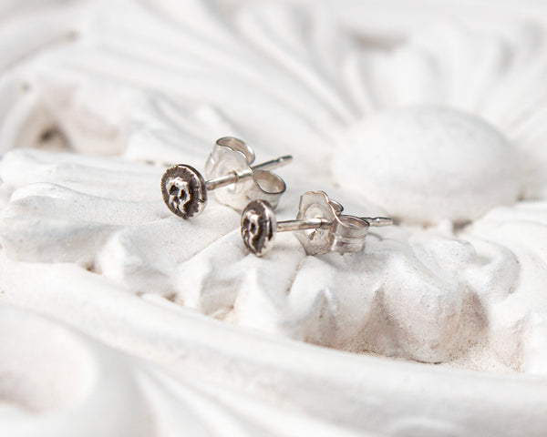 Small sterling silver skull stud earrings