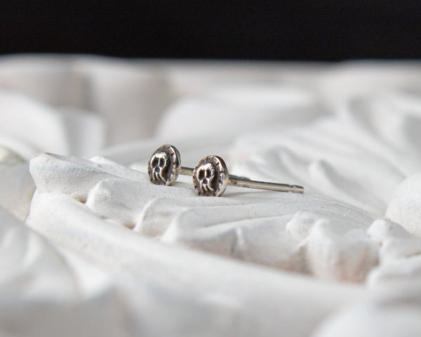 Small sterling silver skull stud earrings