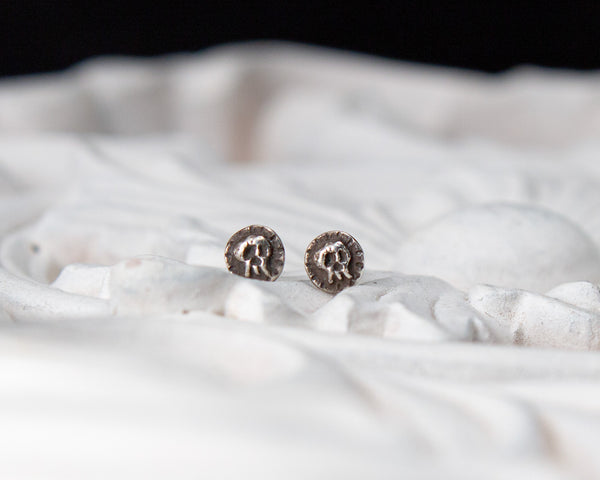 Small sterling silver skull stud earrings