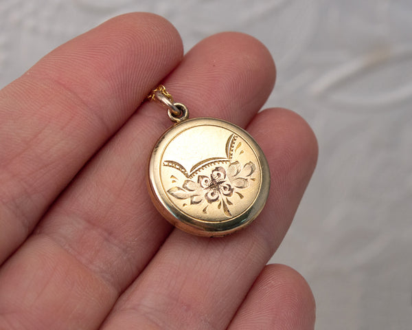 Small, round vintage locket with dog