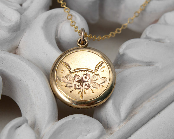 Front of Small, round vintage locket with dog